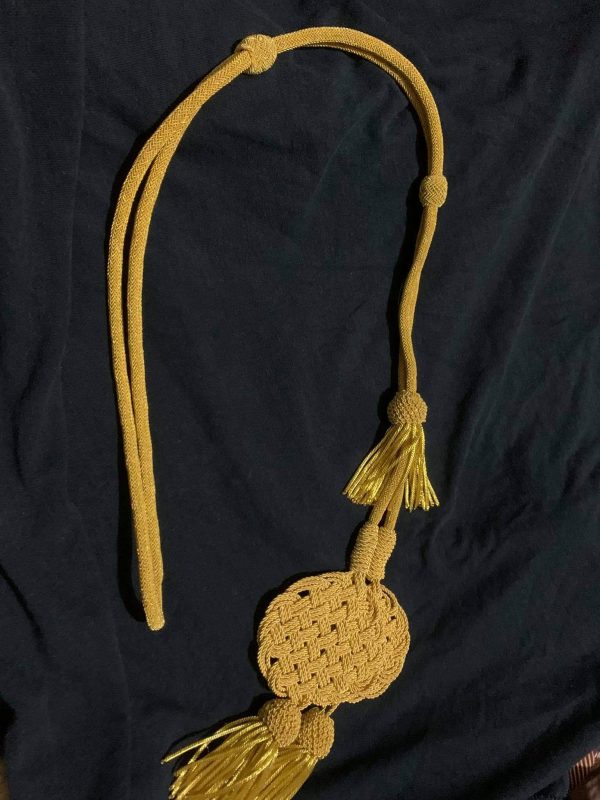 Cord to attach pelisse in ''Trefle''
